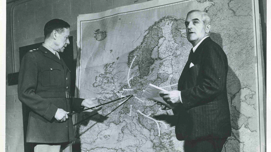 US Army General Allen Gullion and Fred K. Hoehler, Director of the United Nation’s Division of Displaced Persons, stand before a map predicting the movement of European refugees of World War II. Many Europeans would find a haven in refugee camps in the Middle East.