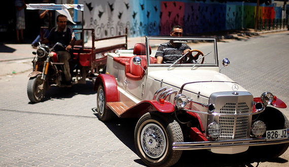 Palestinian Munir Shindi drives a replica of 1927 Mercedes Gazelle that he built from scratch, on a street in Gaza City