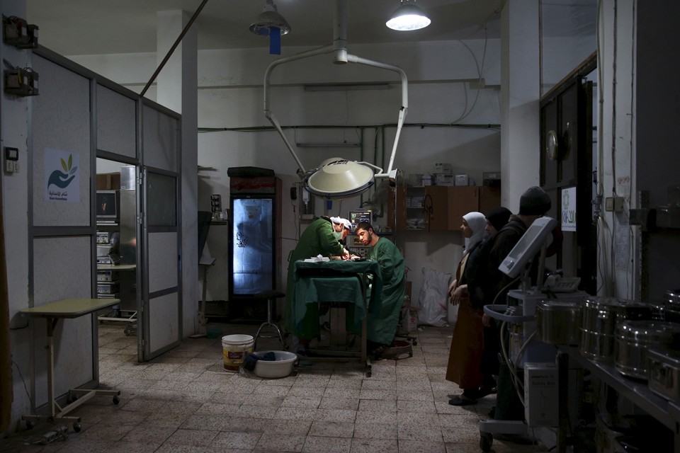 Doctors treat an injured civilian in a field hospital after what activists said was shelling by forces of Syria's President Bashar al-Assad in the Douma neighbourhood of Damascus, Eastern Ghouta, Syria